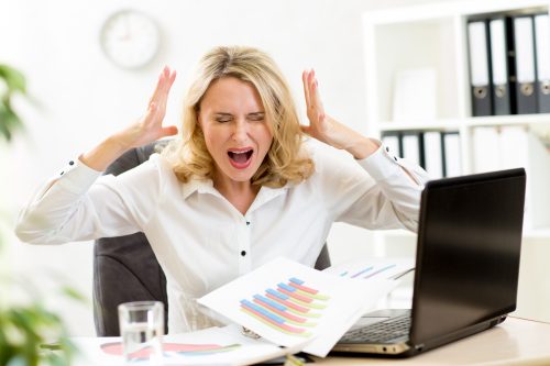Stressed businesswoman at laptop in office
