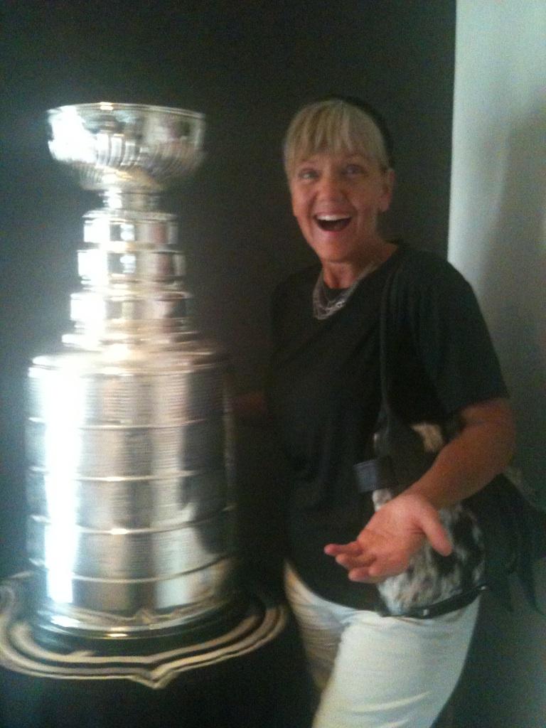 Trisha, a Body Charge therapist, next to the Stanley Cup at the party Saturday the 16th of June